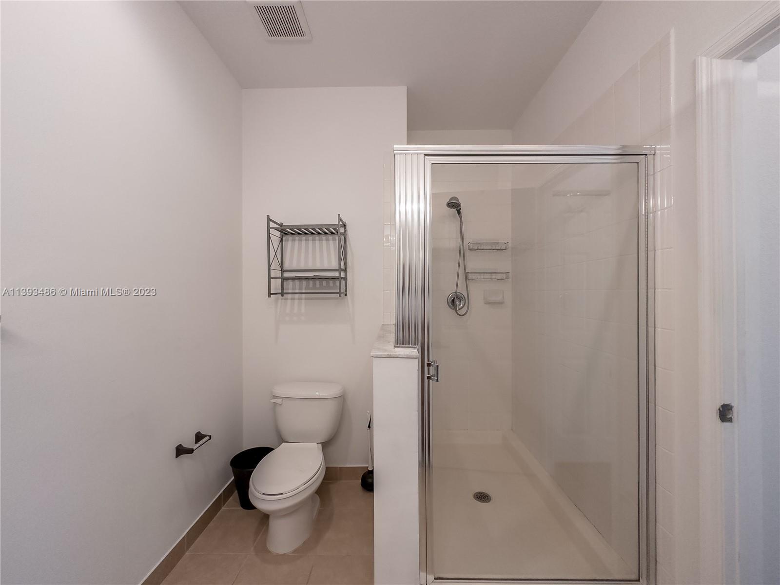 865 Southwest 147th Avenue, Unit 1908 Pembroke Pines, FL 33027 - Photo 21 of 30 a bathroom with a toilet and a shower