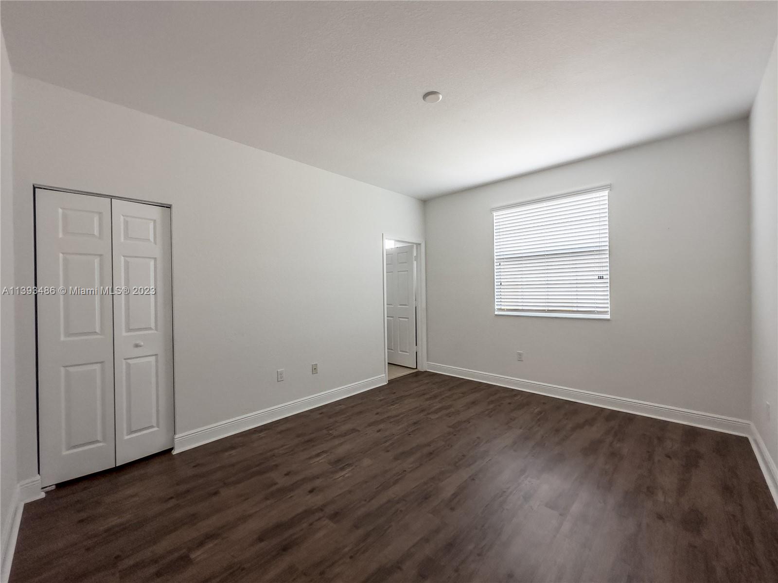 865 Southwest 147th Avenue, Unit 1908 Pembroke Pines, FL 33027 - Photo 22 of 30 an empty room with wooden floor and windows