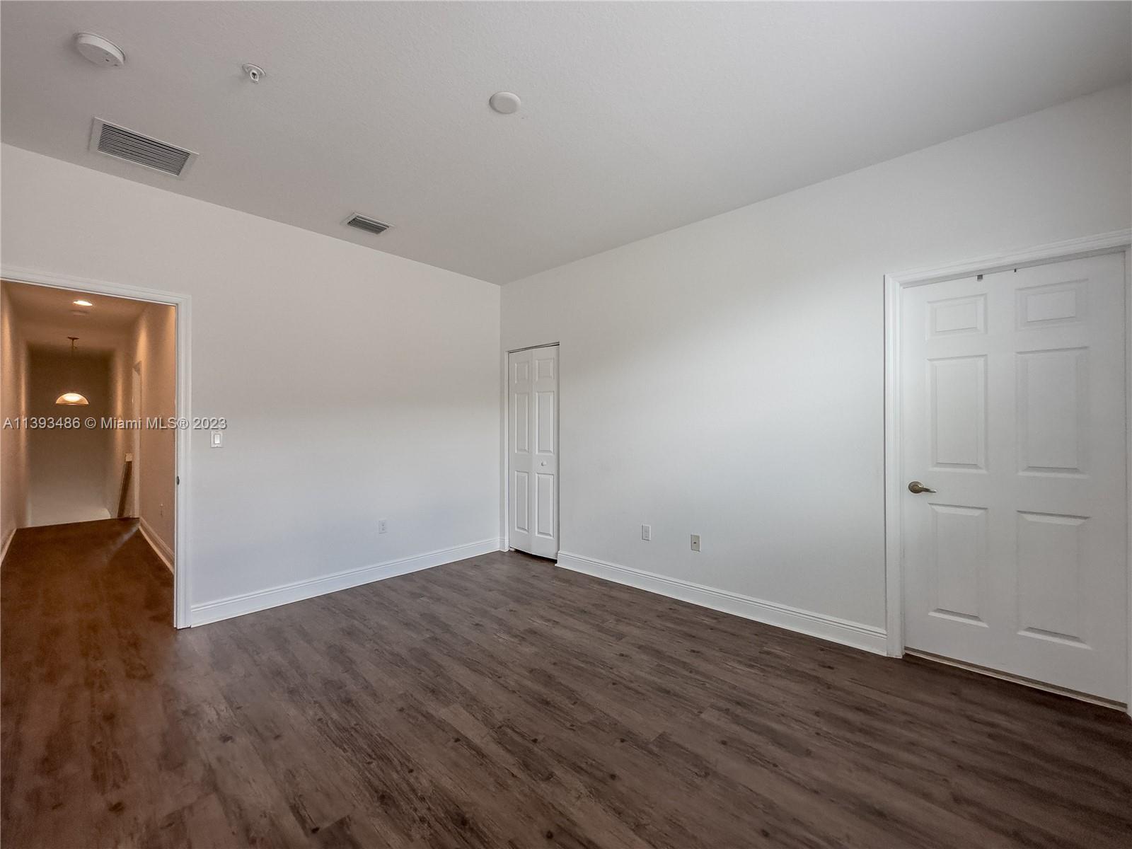 865 Southwest 147th Avenue, Unit 1908 Pembroke Pines, FL 33027 - Photo 24 of 30 a view of an empty room with wooden floor and closet