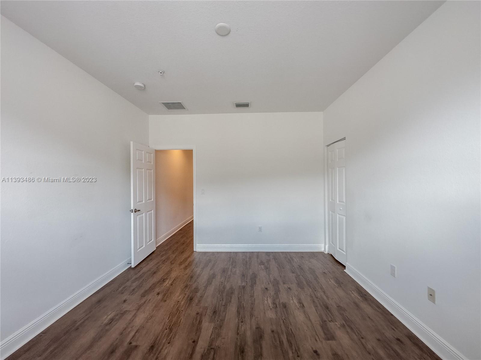 865 Southwest 147th Avenue, Unit 1908 Pembroke Pines, FL 33027 - Photo 25 of 30 a view of an empty room with wooden floor