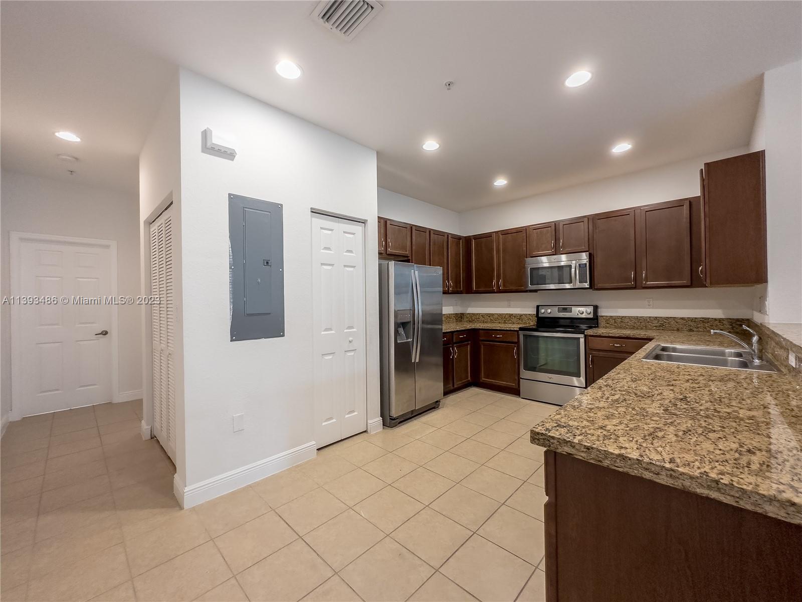 865 Southwest 147th Avenue, Unit 1908 Pembroke Pines, FL 33027 - Photo 8 of 30 a kitchen with stainless steel appliances granite countertop a refrigerator and a sink