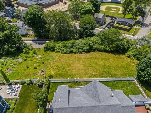an aerial view of a houses with a yard