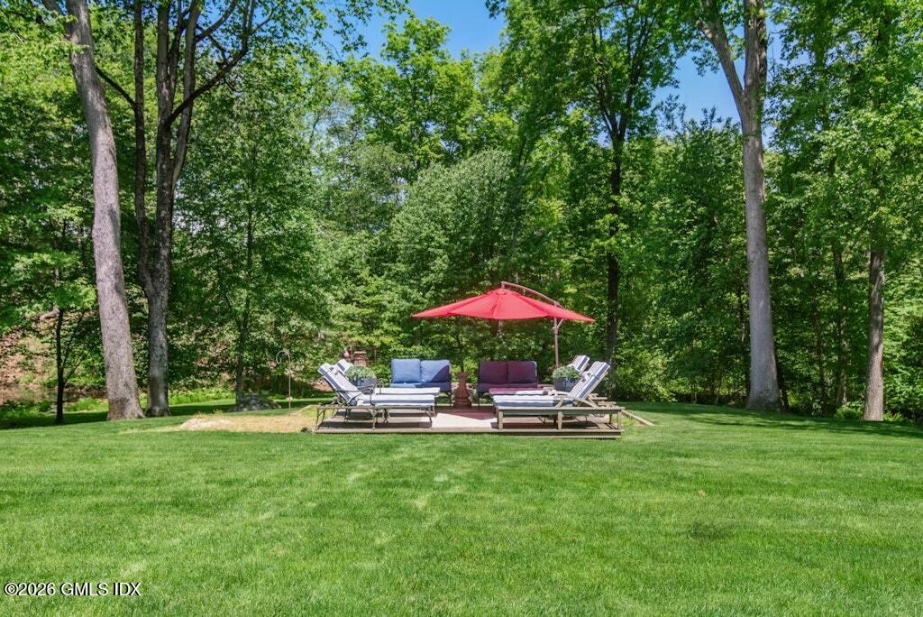 73 Thunder Mountain Road Greenwich, CT 06831 - Photo 16 of 19 a view of a table and chairs under an umbrella