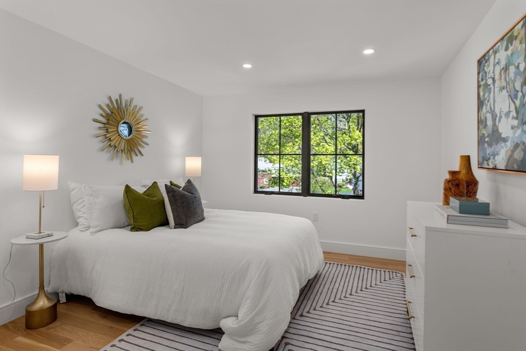 470 Quinobequin Road Newton, MA 02468 - Photo 27 of 37 a bedroom with a bed and a window