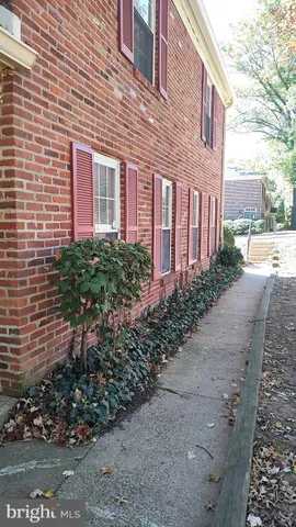 a view of a brick house with a yard