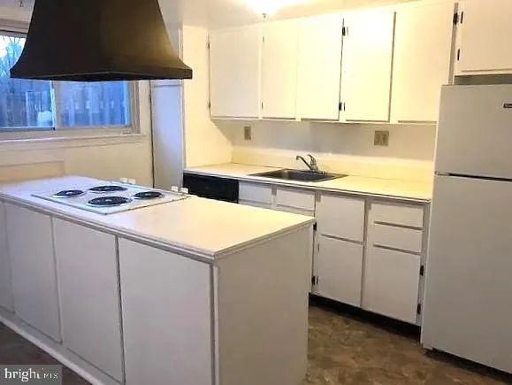 a kitchen with cabinets appliances and a sink