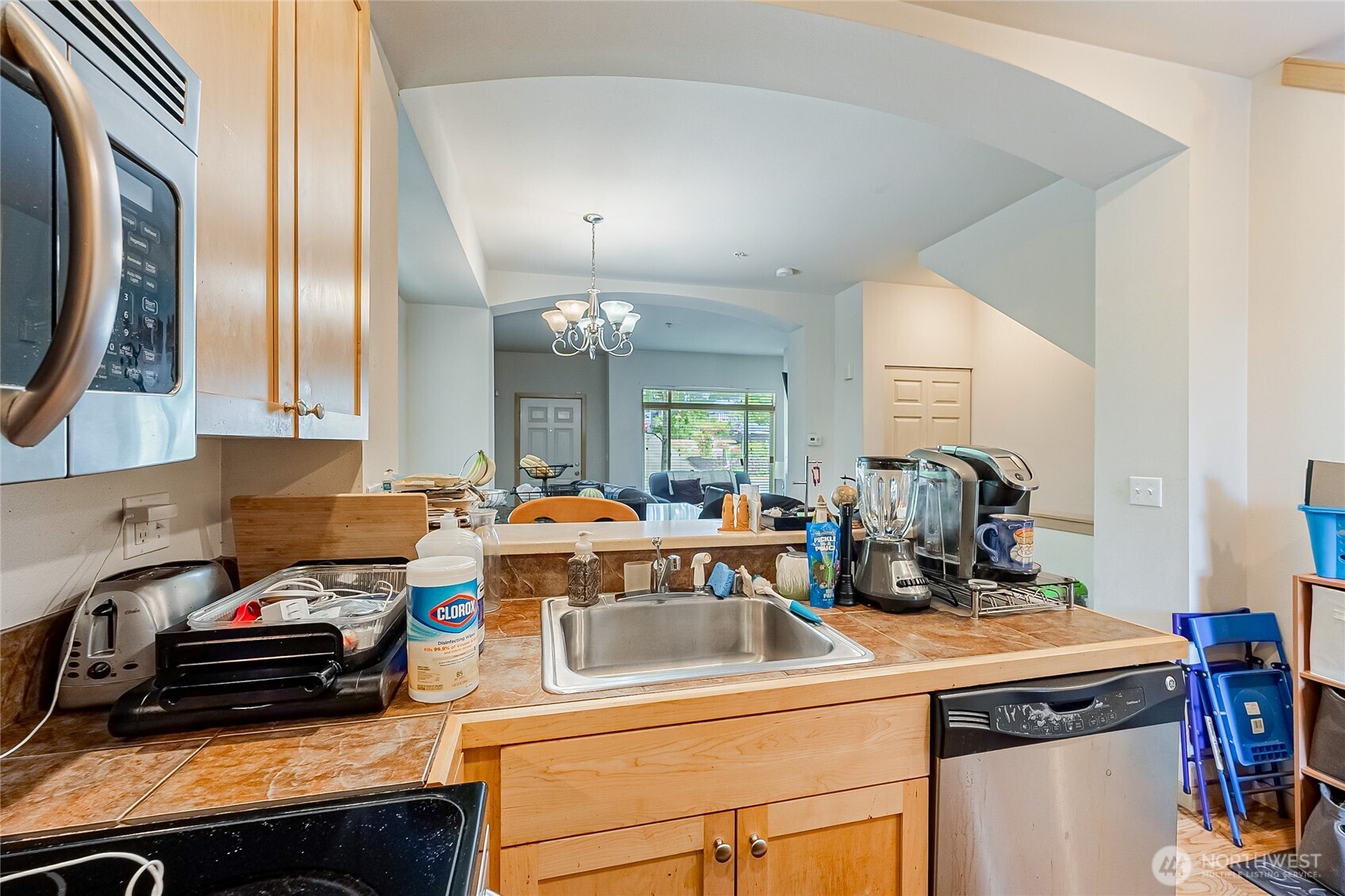 13005 64th Avenue South, Unit B117 Seattle, WA 98178 - Photo 13 of 37 a kitchen with a sink stove and cabinets