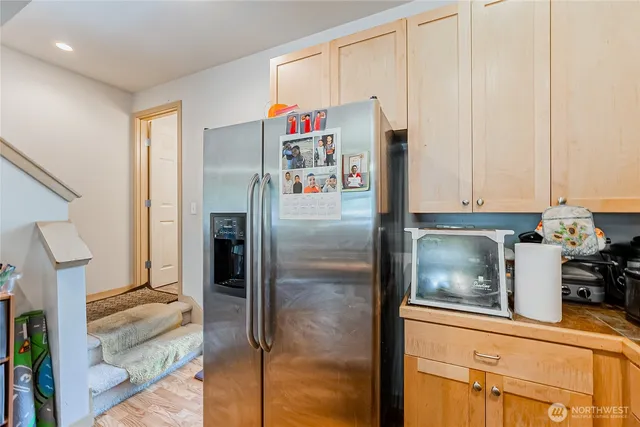 a refrigerator freezer sitting inside of a kitchen