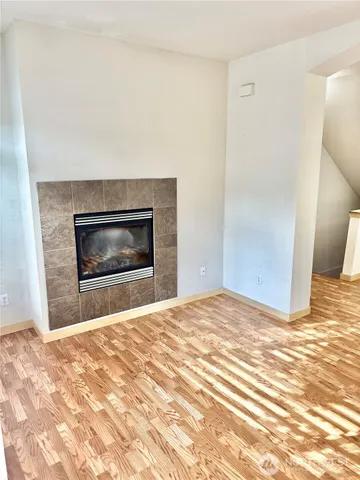 a view of empty room with a fireplace