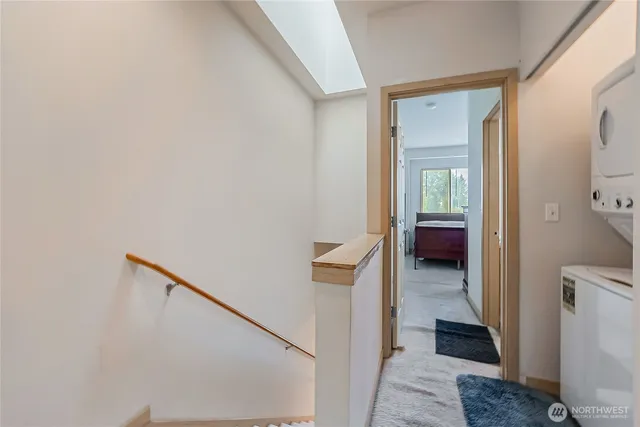 a view of a hallway with a livingroom and a bathroom