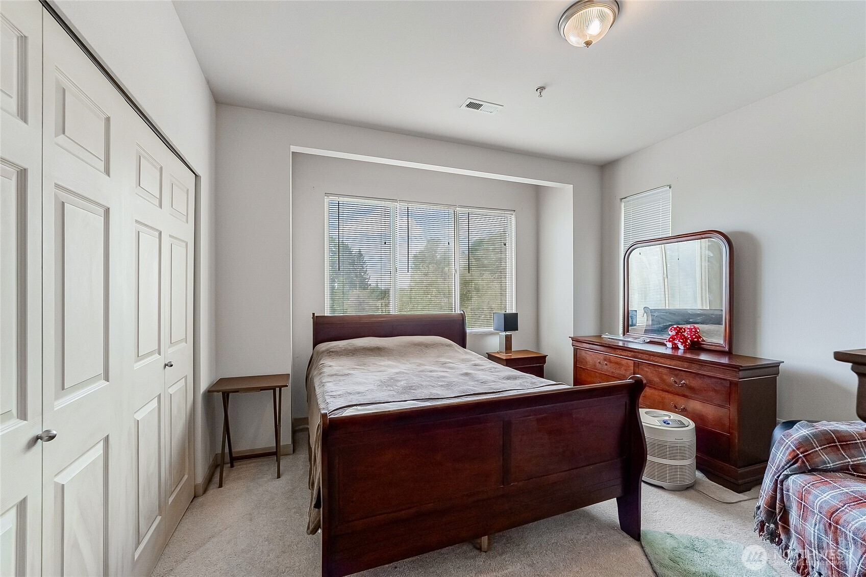 13005 64th Avenue South, Unit B117 Seattle, WA 98178 - Photo 27 of 37 a room with a bed table chair and a window