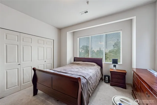 a bed room with a bed and a window