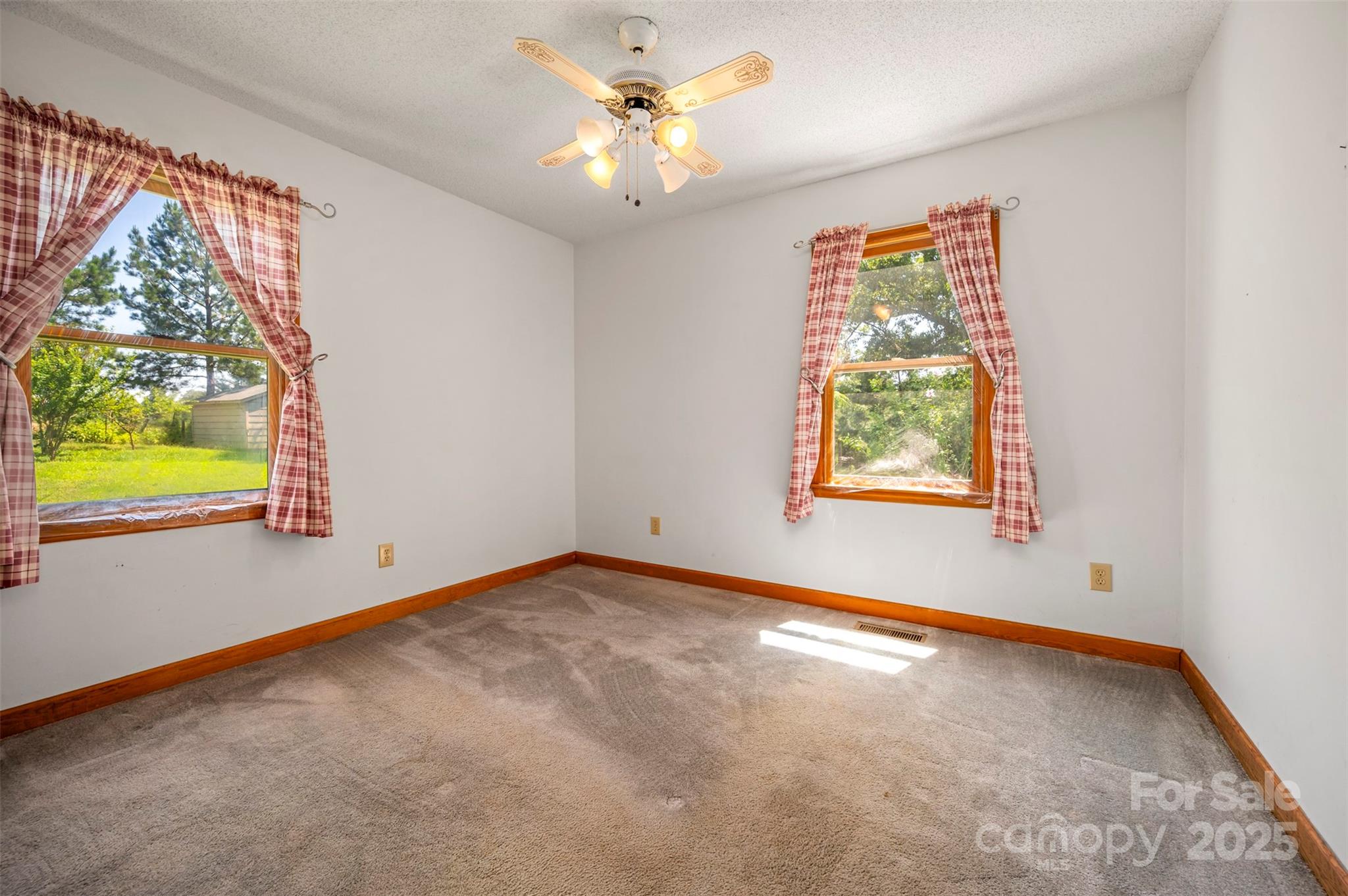49 Meadowbrook Road Rutherfordton, NC 28139 - Photo 11 of 34 an empty room with windows and chandelier fan