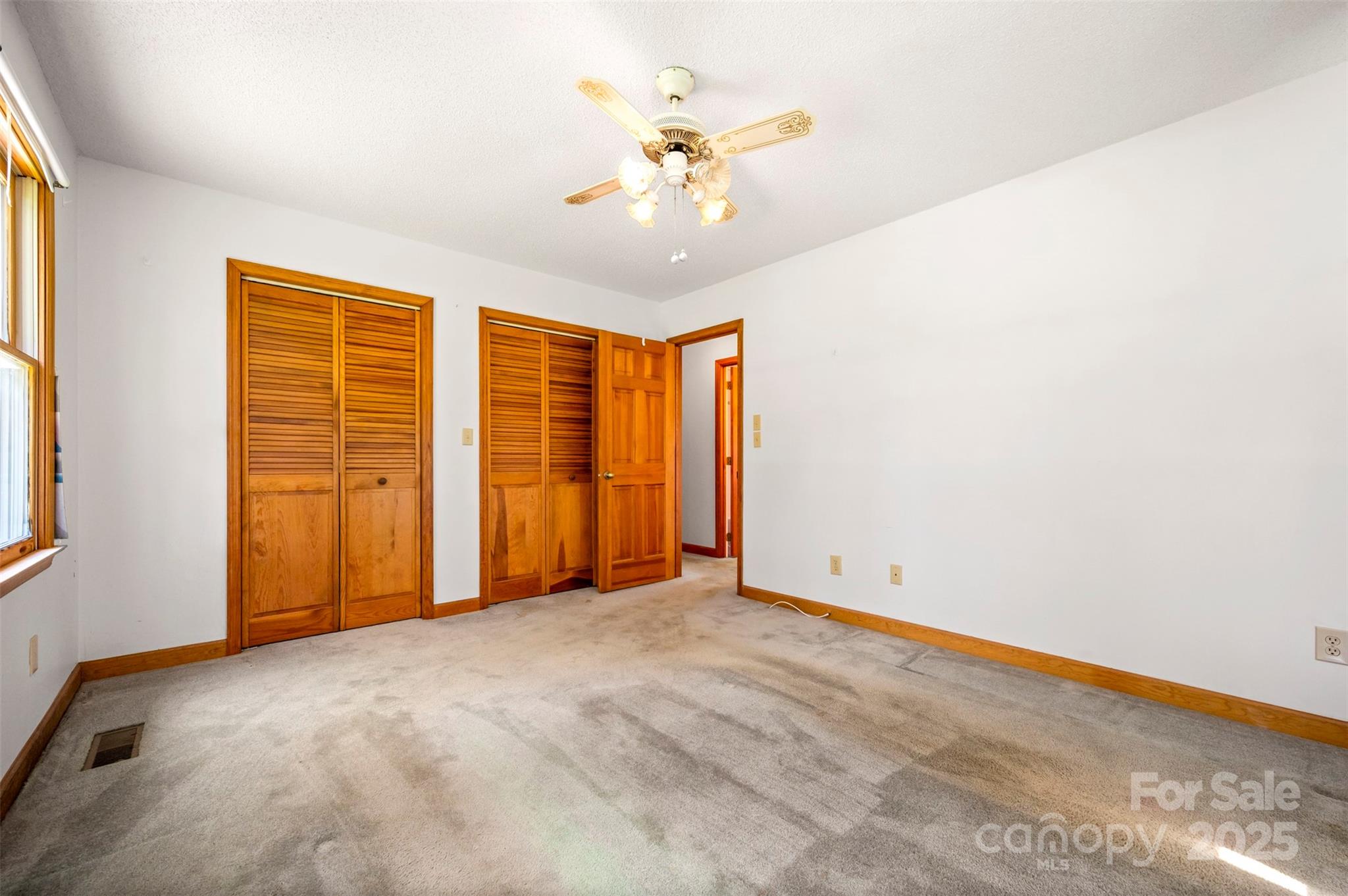 49 Meadowbrook Road Rutherfordton, NC 28139 - Photo 14 of 34 an empty room with chandelier fan and windows