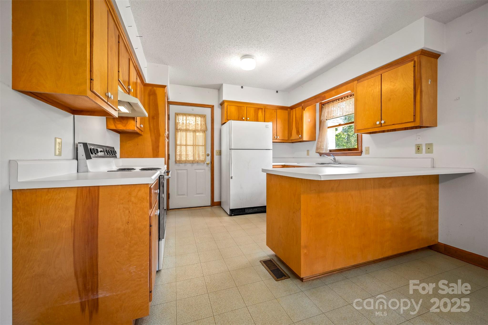 49 Meadowbrook Road Rutherfordton, NC 28139 - Photo 6 of 34 a kitchen with stainless steel appliances granite countertop a sink and a refrigerator