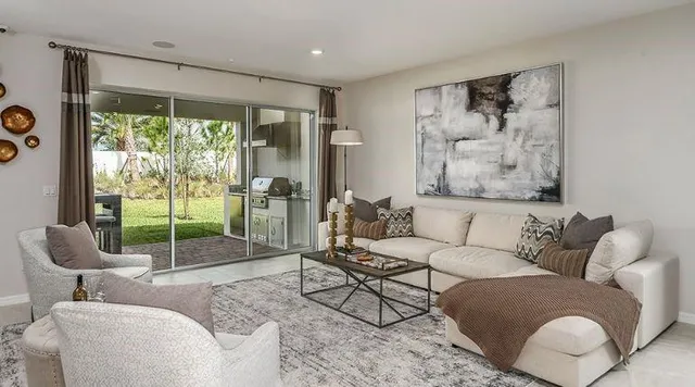 a kitchen with granite countertop a sink and white cabinets