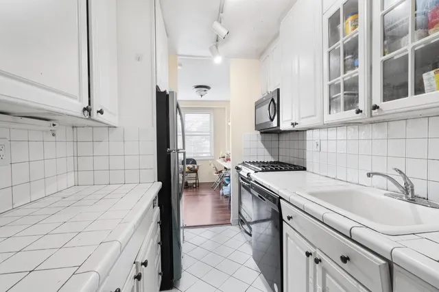 a kitchen with a sink stove and cabinets