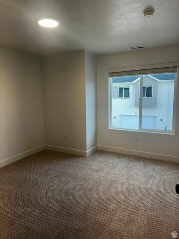 61 South Lunar Way Mapleton, UT 84664 - Photo 12 of 15 Carpeted empty room with a textured ceiling, a smoke detector, and recessed lighting