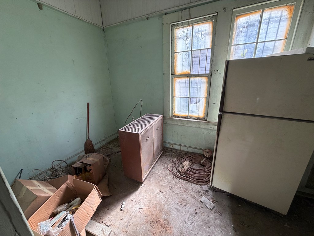 1124 20th Street Columbus, GA 31901 - Photo 28 of 30 a room with a couch and a refrigerator