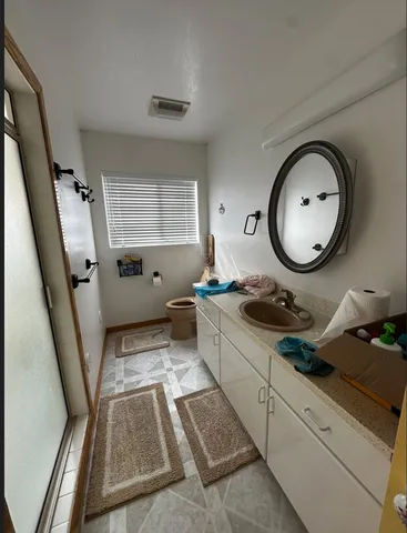 a bathroom with a granite countertop sink and a mirror