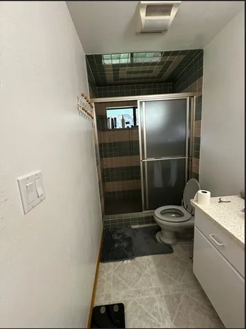 a bathroom with a toilet a sink and mirror