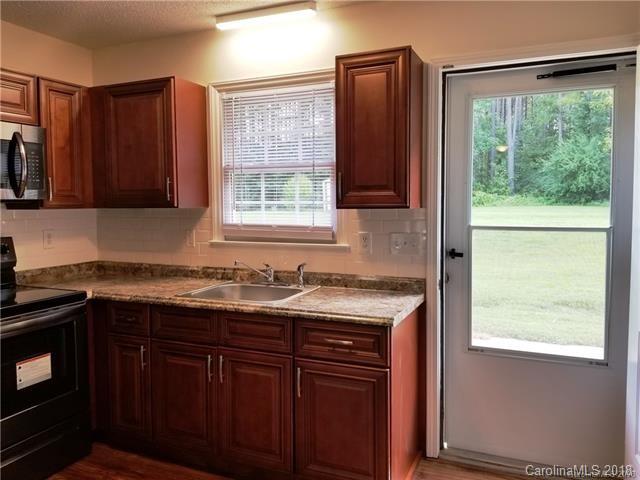 2286 Beth Haven Church Road, Unit 2286 Denver, NC 28037 - Photo 7 of 15 a kitchen with stainless steel appliances granite countertop wooden cabinets a sink and a window