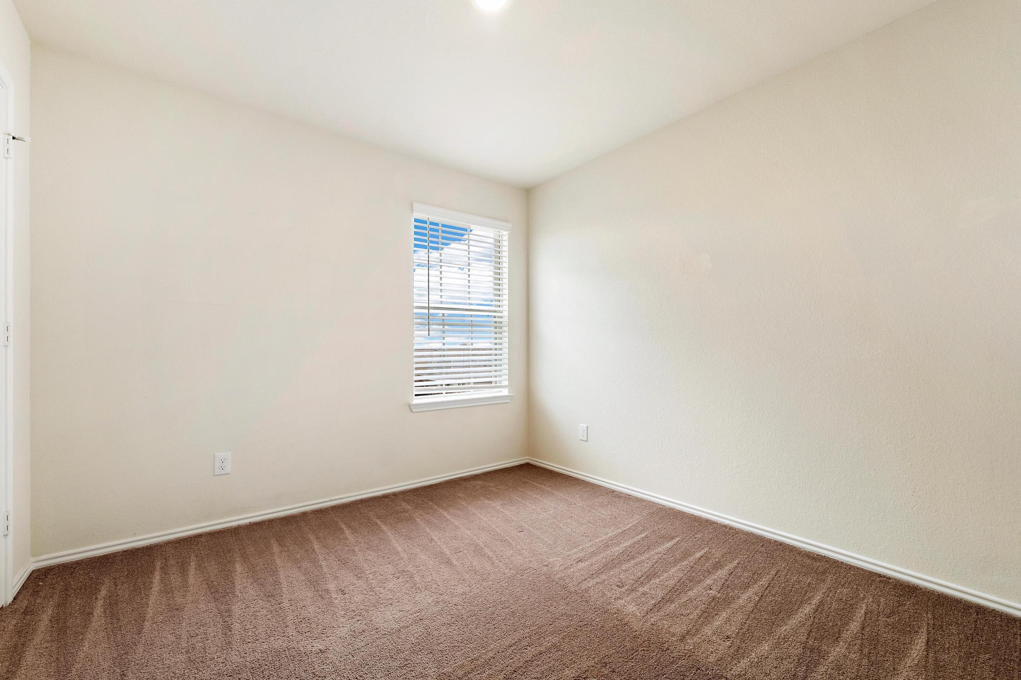 217 Innisfree Road Jarrell, TX 76537 - Photo 27 of 39 A well-lit, neutral-toned room ready for personalization.