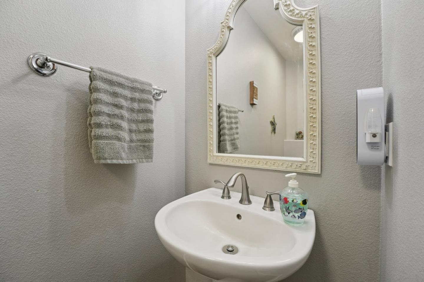 476 Arcadia Way Salinas, CA 93906 - Photo 16 of 40 a bathroom with a sink and a mirror