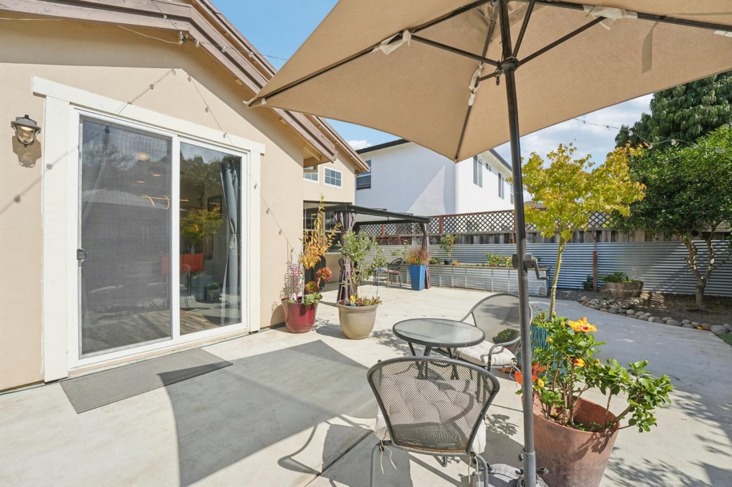 476 Arcadia Way Salinas, CA 93906 - Photo 34 of 40 a view of a patio with table and chairs under an umbrella