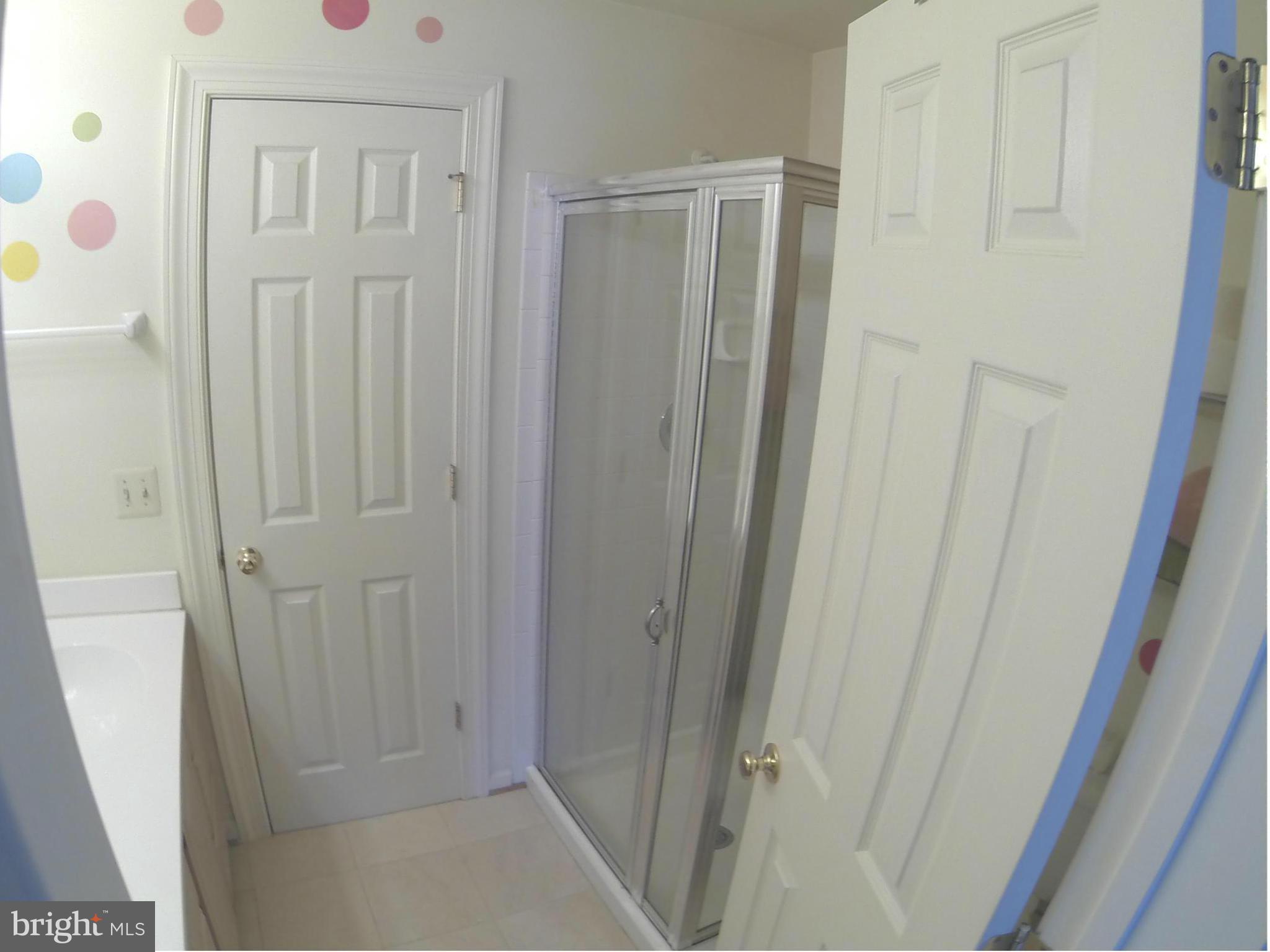 17045 Islip Loop, Unit 301 Dumfries, VA 22026 - Photo 11 of 14 a bathroom with a shower curtain