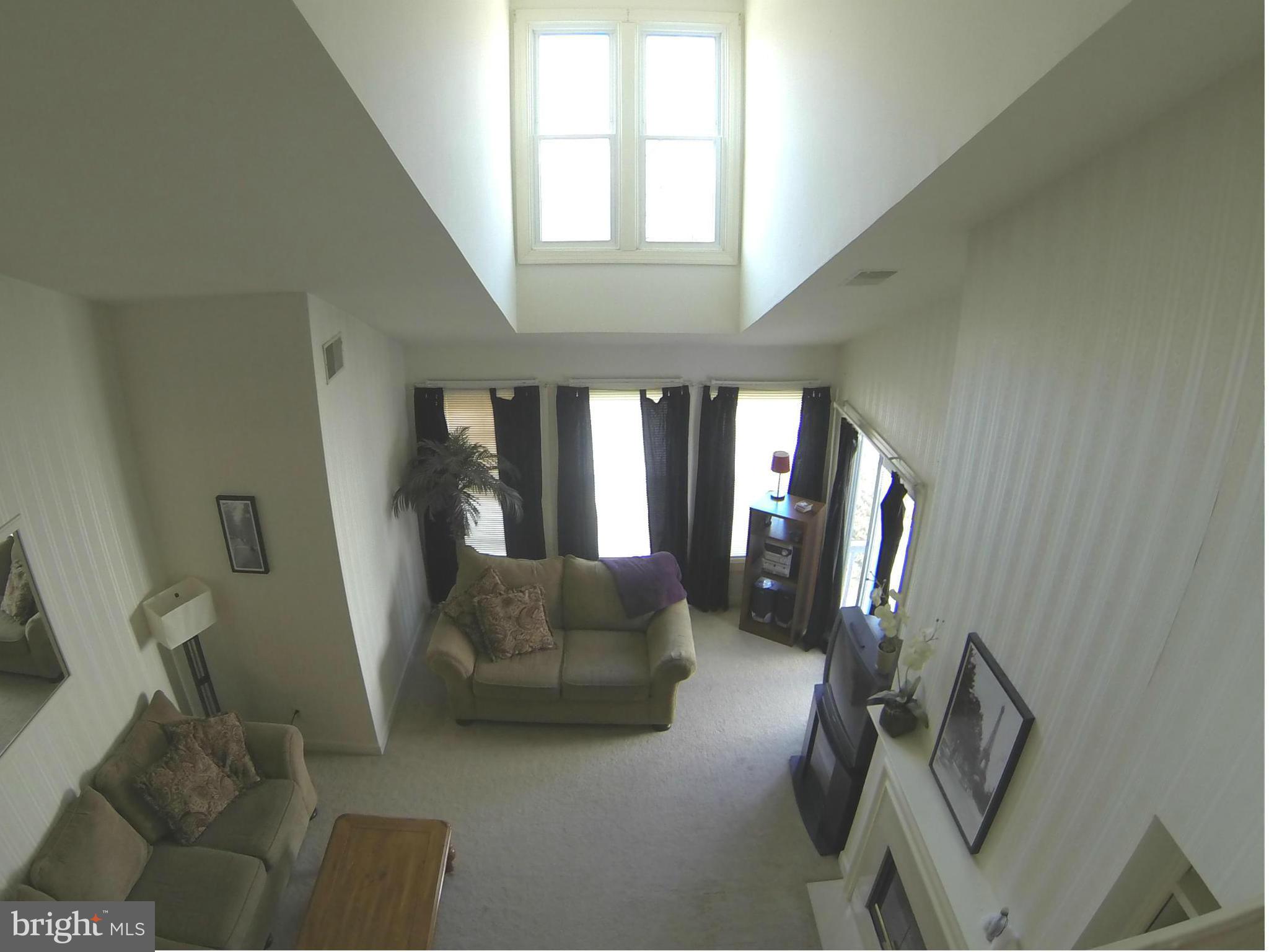 17045 Islip Loop, Unit 301 Dumfries, VA 22026 - Photo 14 of 14 a living room with furniture and a large window