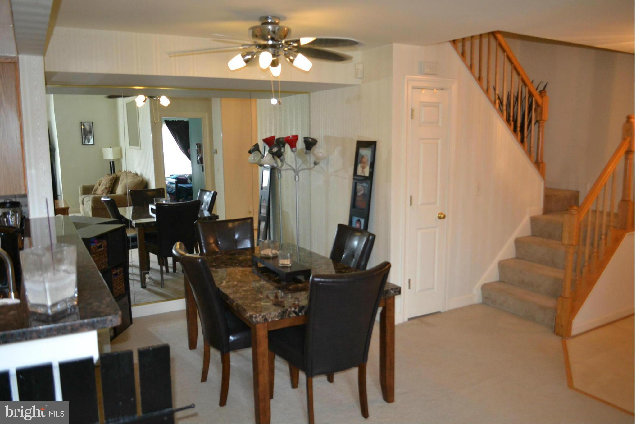 17045 Islip Loop, Unit 301 Dumfries, VA 22026 - Photo 4 of 14 a view of a dining room with furniture and chandelier