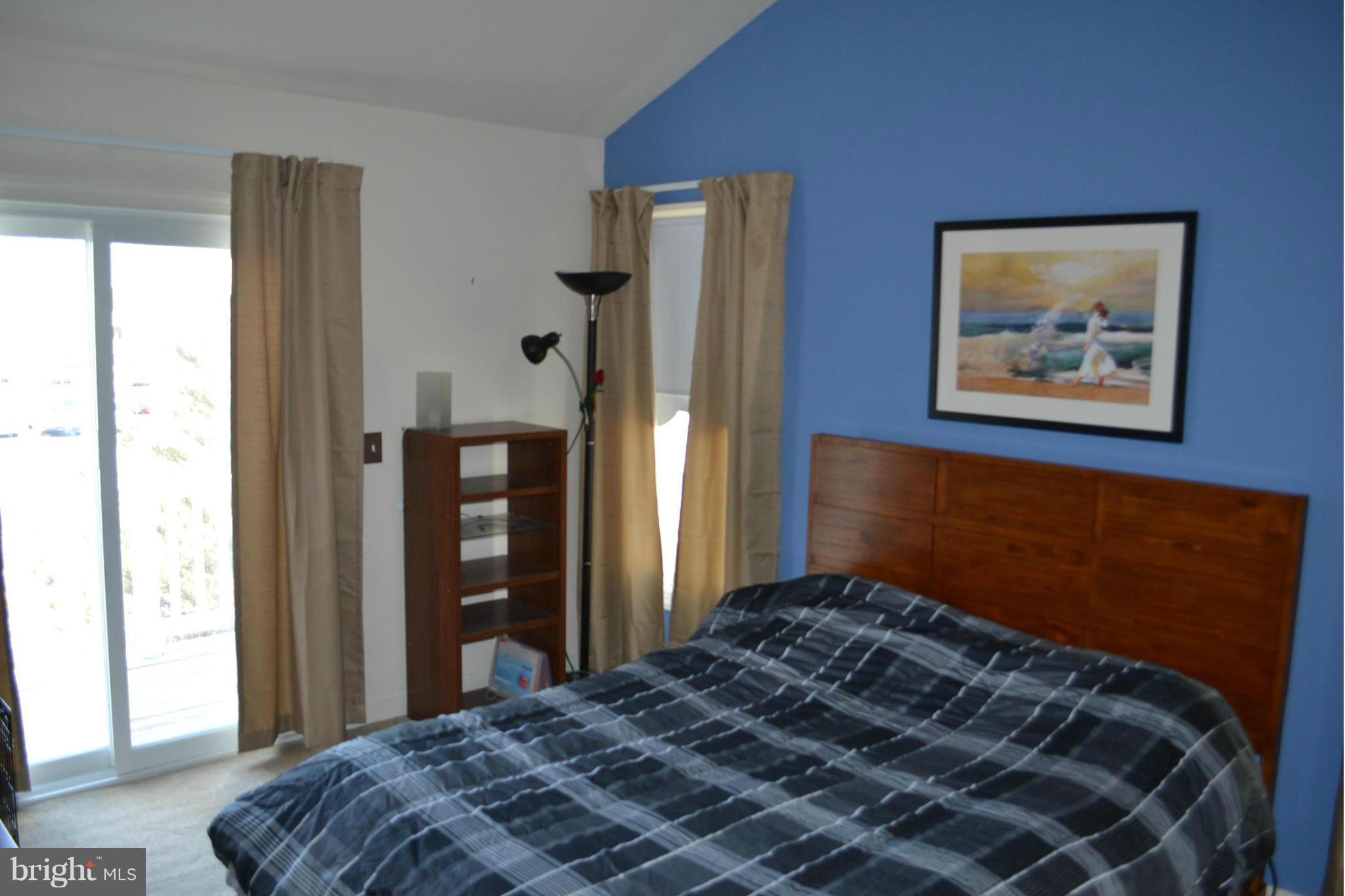 17045 Islip Loop, Unit 301 Dumfries, VA 22026 - Photo 6 of 14 a bedroom with a bed and a window
