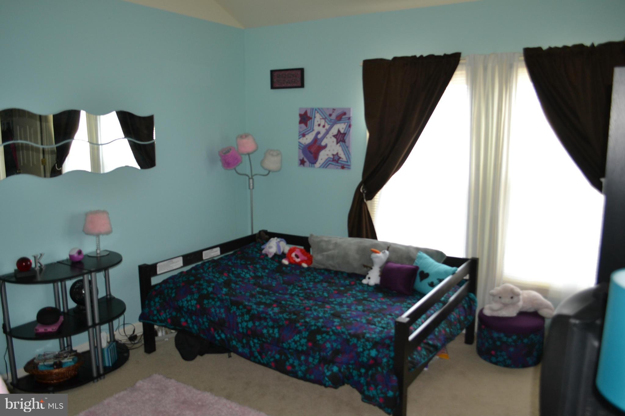 17045 Islip Loop, Unit 301 Dumfries, VA 22026 - Photo 9 of 14 a bed room with a bed and a window
