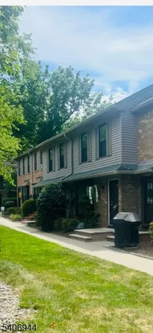 a view of house with a yard