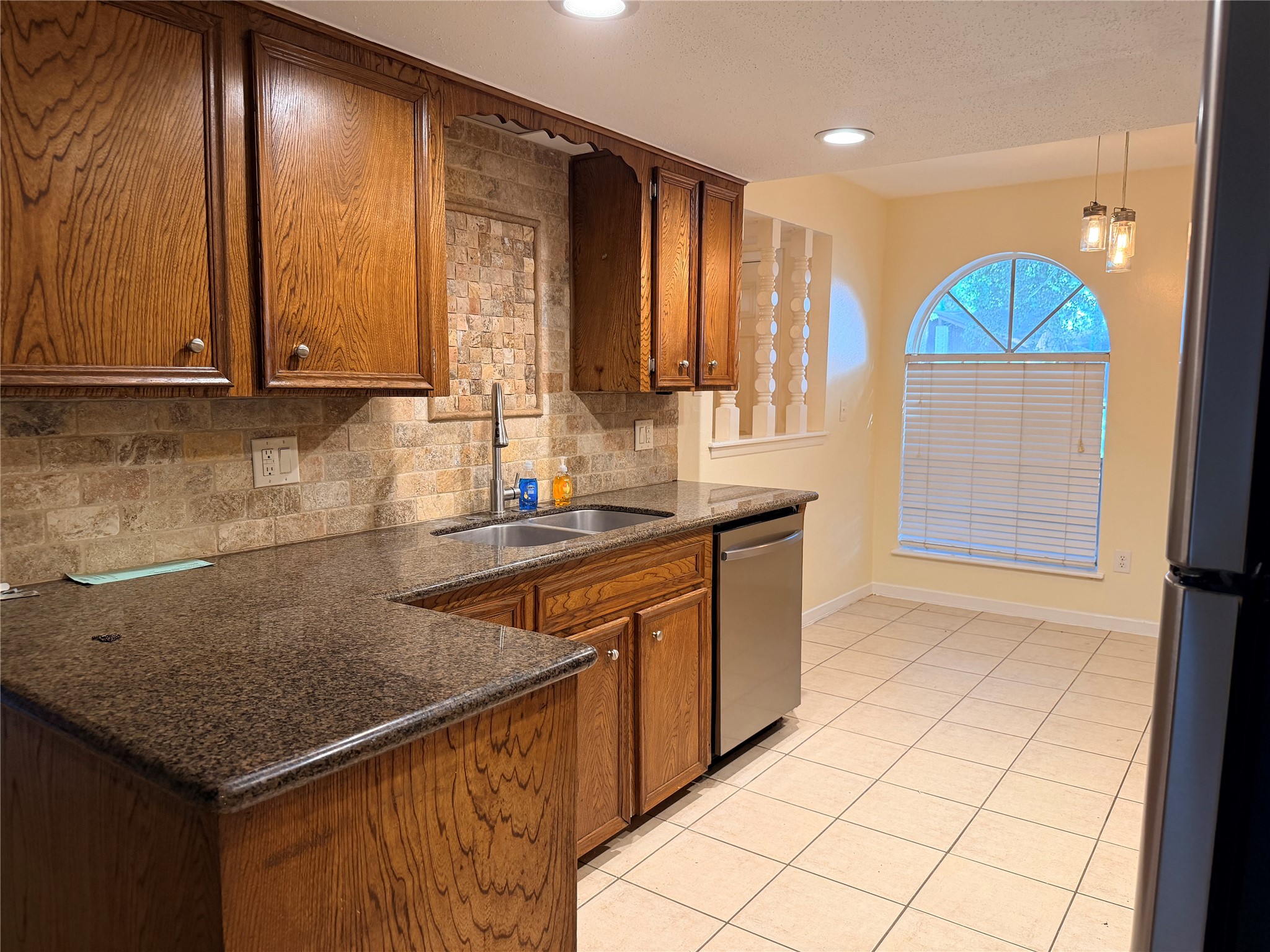 2439 Meandering Trail Houston, TX 77339 - Photo 3 of 8 a kitchen with stainless steel appliances granite countertop a sink a stove and a microwave