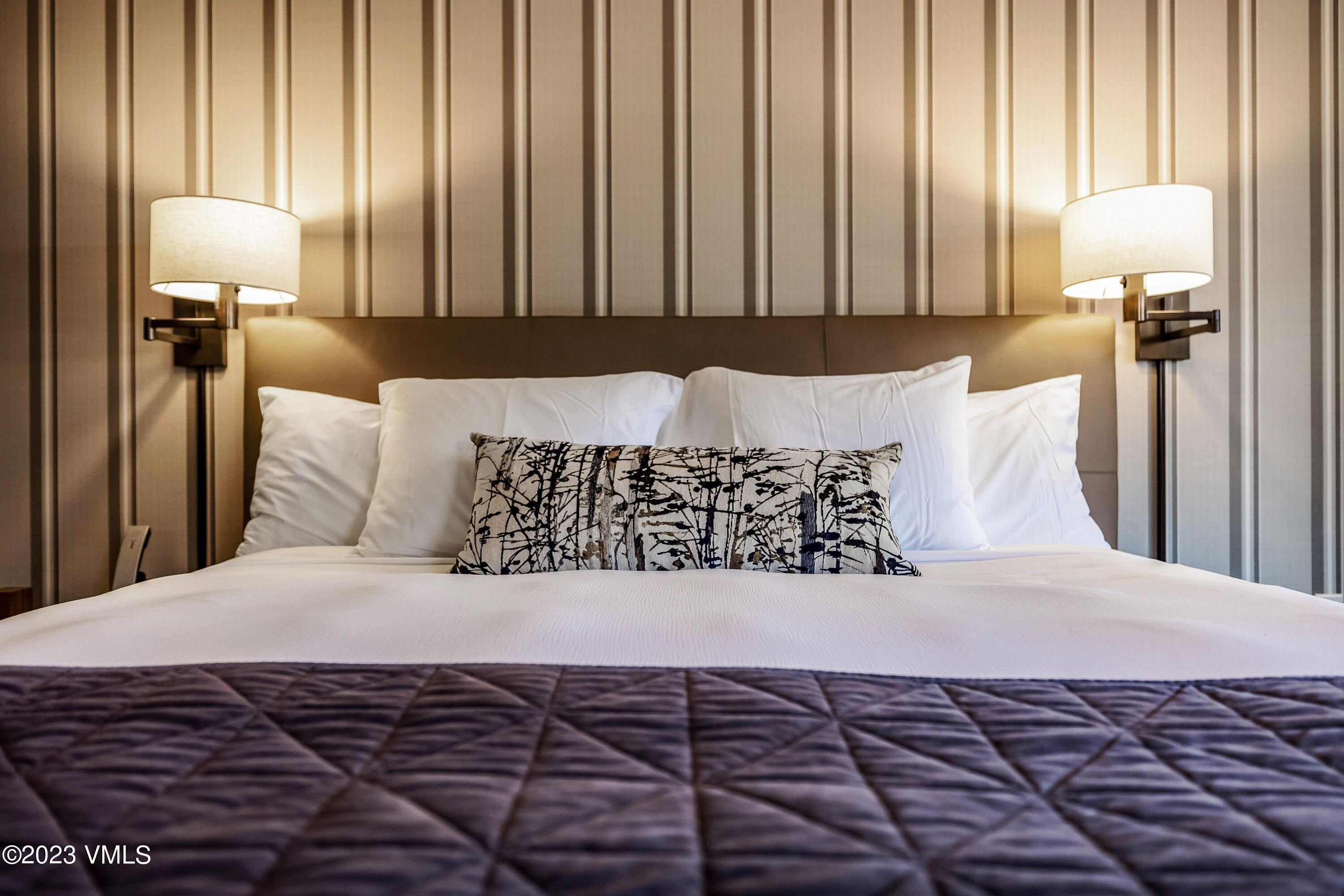 16 Vail Road, Unit RESORT MEMBERSHIP Vail, CO 81657 - Photo 13 of 51 a large bed sitting in a bedroom next to a window