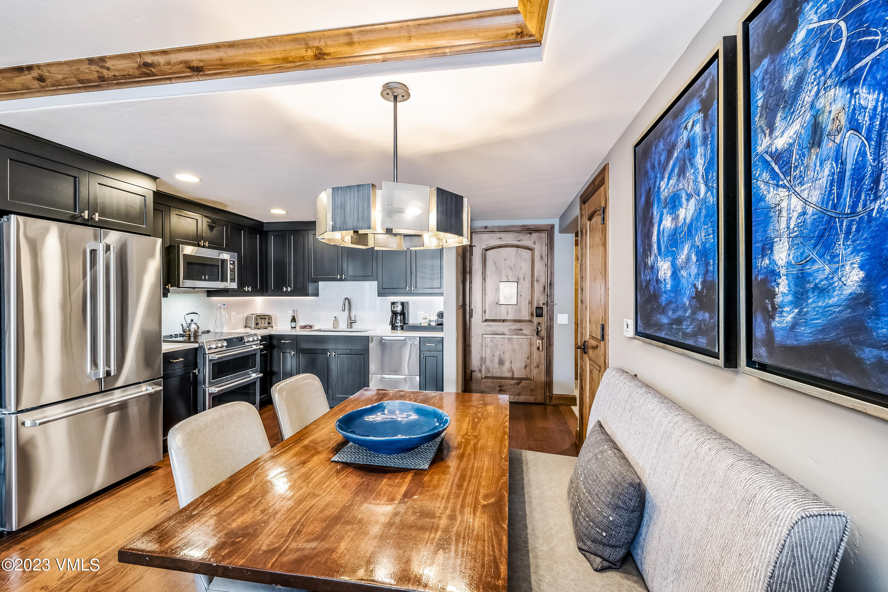16 Vail Road, Unit RESORT MEMBERSHIP Vail, CO 81657 - Photo 17 of 51 a kitchen with stainless steel appliances granite countertop a sink refrigerator and microwave