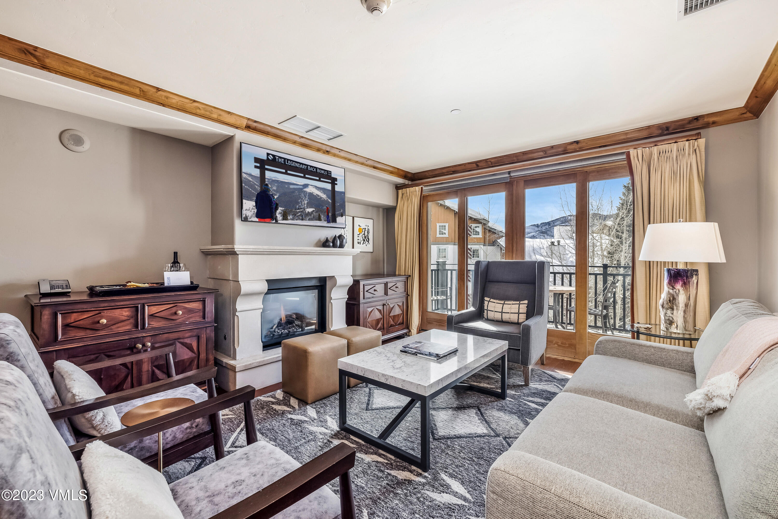 16 Vail Road, Unit RESORT MEMBERSHIP Vail, CO 81657 - Photo 22 of 51 a living room with furniture a fireplace and a table