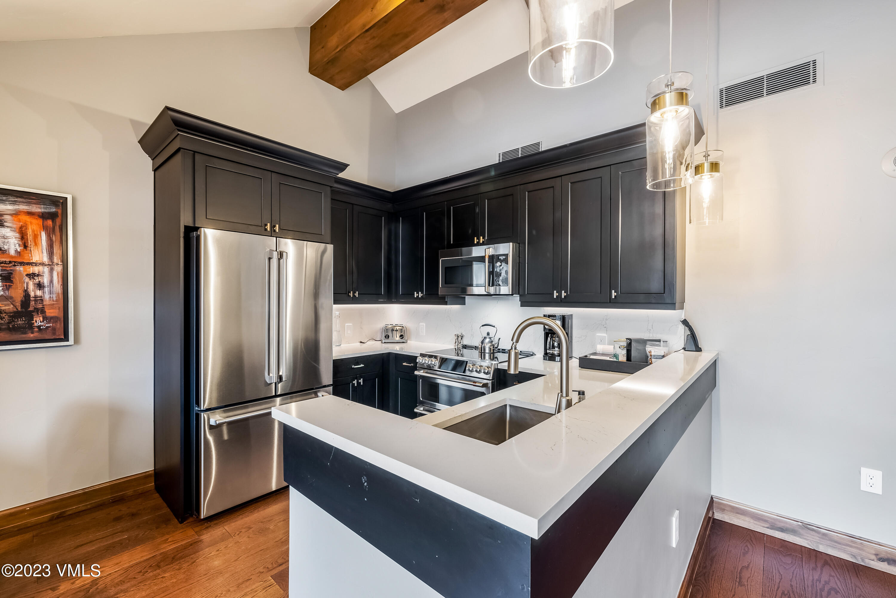 16 Vail Road, Unit RESORT MEMBERSHIP Vail, CO 81657 - Photo 6 of 51 a kitchen that has a sink cabinets counter space and stainless steel appliances