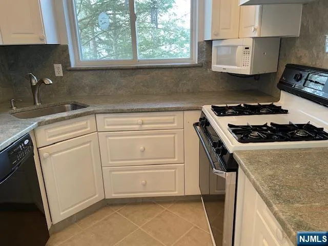 a kitchen with a stove and a sink