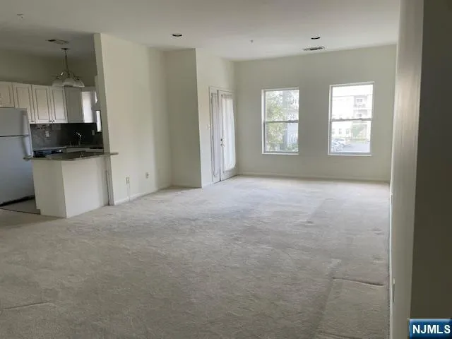 a view of a kitchen with flat screen tv and window