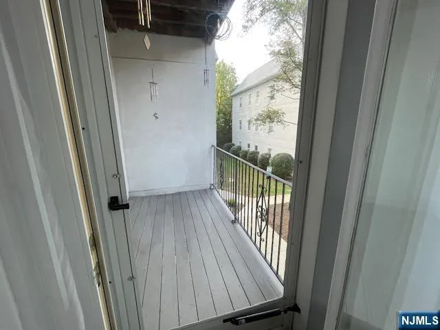 a view of a balcony with wooden floor