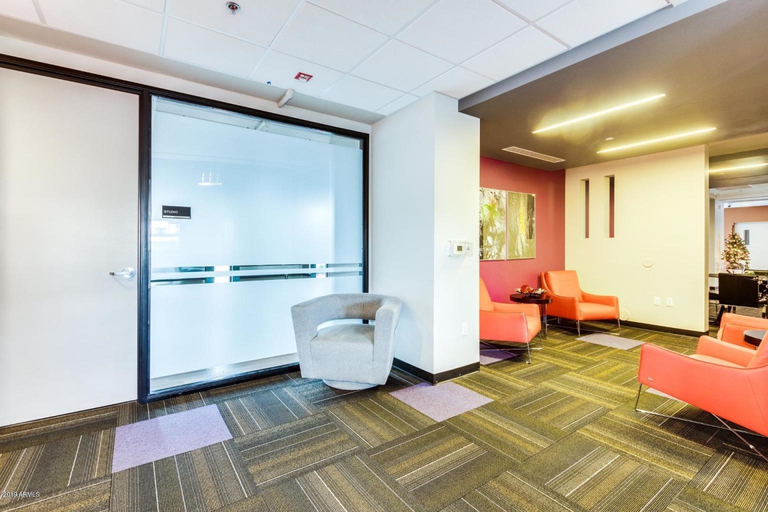 535 West Thomas Road, Unit 211 Phoenix, AZ 85013 - Photo 13 of 24 a spacious bedroom with a bed and large windows