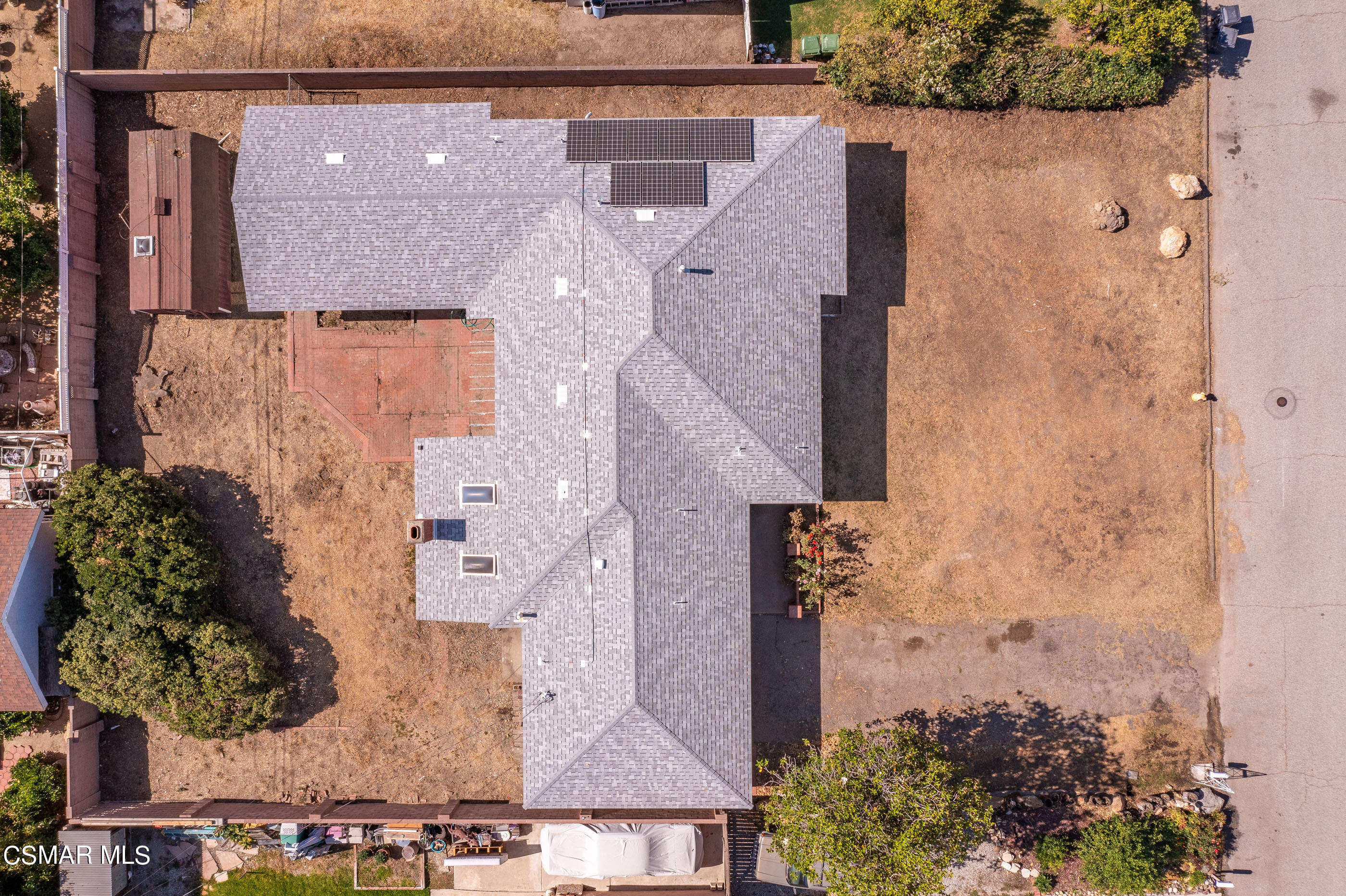 an aerial view of a house with a yard and a fountain