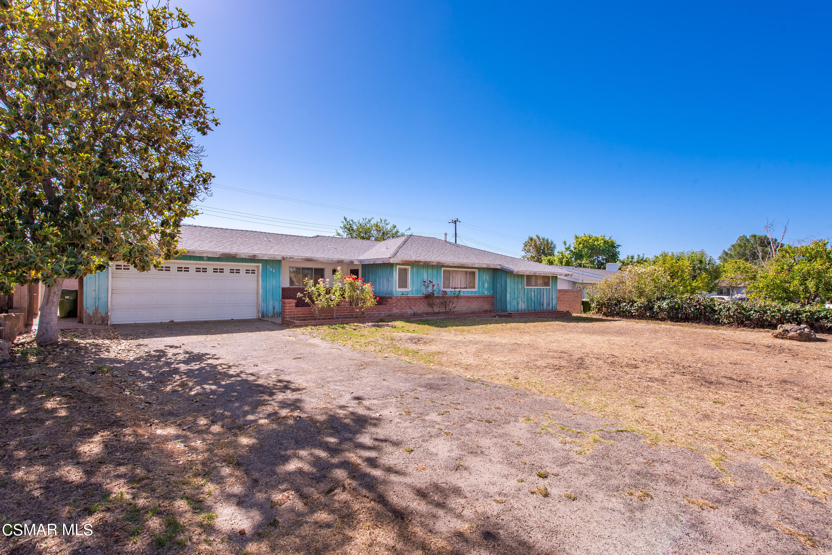 3140 Sheri Drive Simi Valley, CA 93063 - Photo 4 of 38 a front view of a house with a yard and a garage