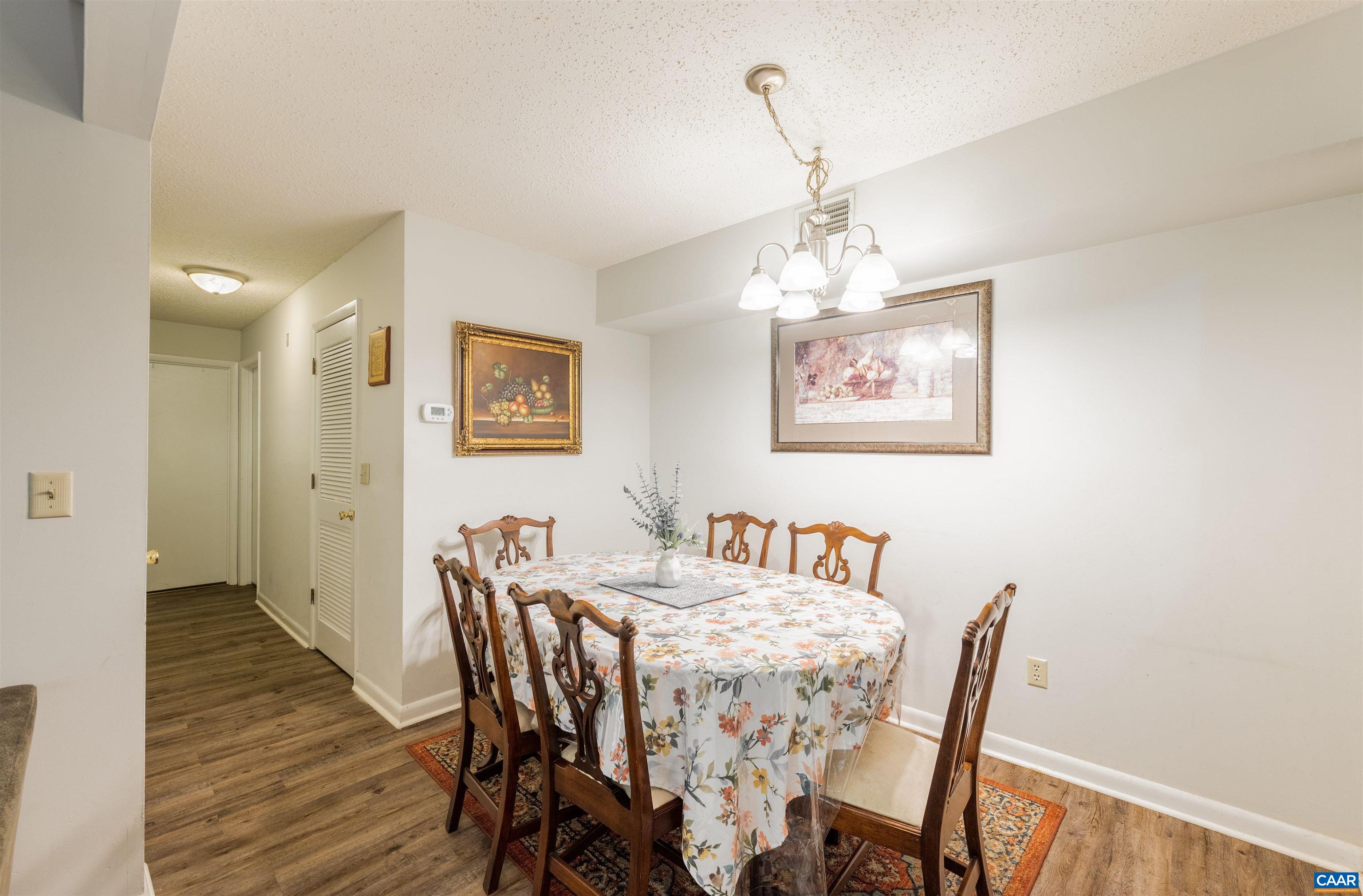 109 Turtle Creek Road, Unit 7 Charlottesville, VA 22901 - Photo 11 of 27 a view of a dining room with furniture wooden floor and a chandelier