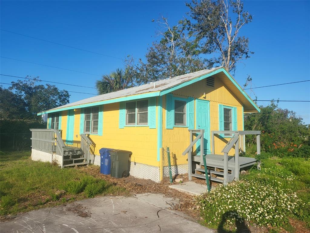 a view of a house with backyard sitting area and garden