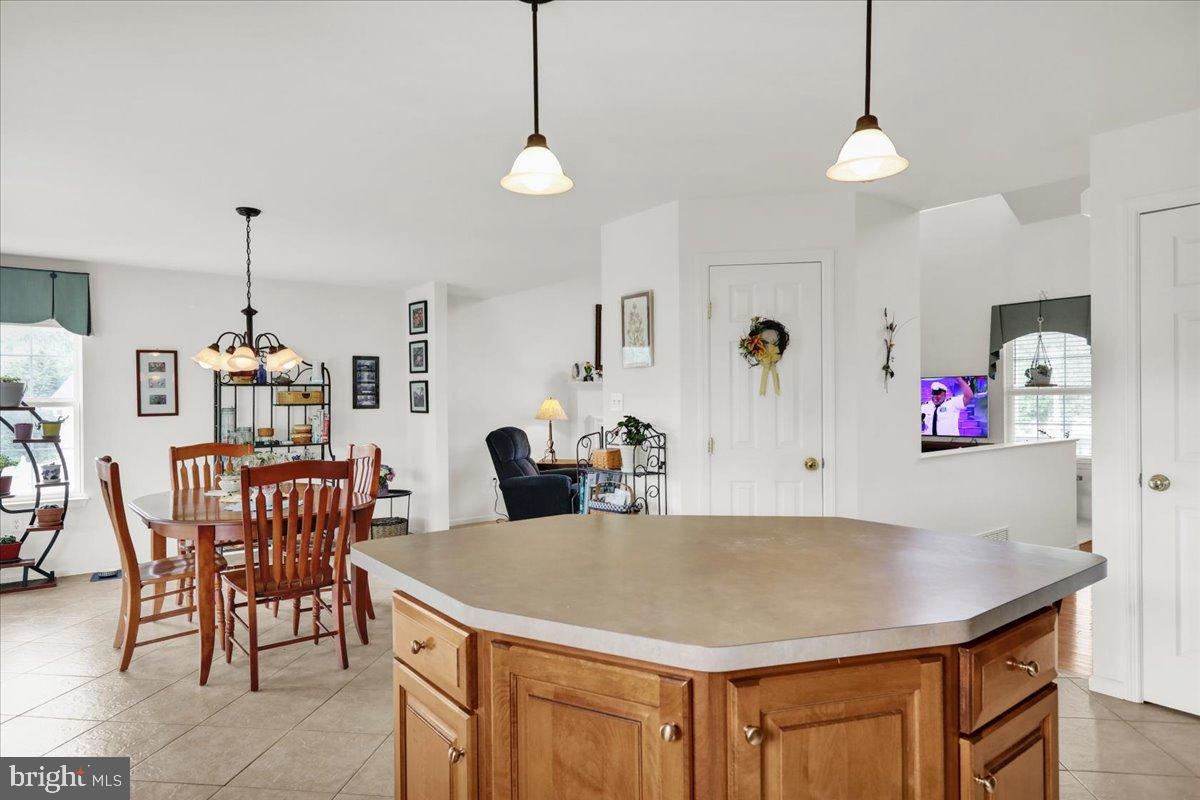 2509 Joshua Drive Sinking Spring, PA 19608 - Photo 12 of 35 a view of kitchen island with stainless steel appliances furniture refrigerator dining table and chairs