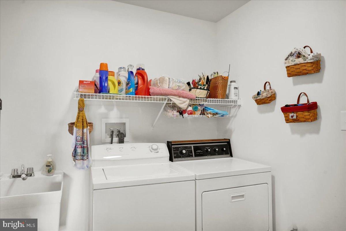 2509 Joshua Drive Sinking Spring, PA 19608 - Photo 15 of 35 a utility room with dryer washer and shoe rack